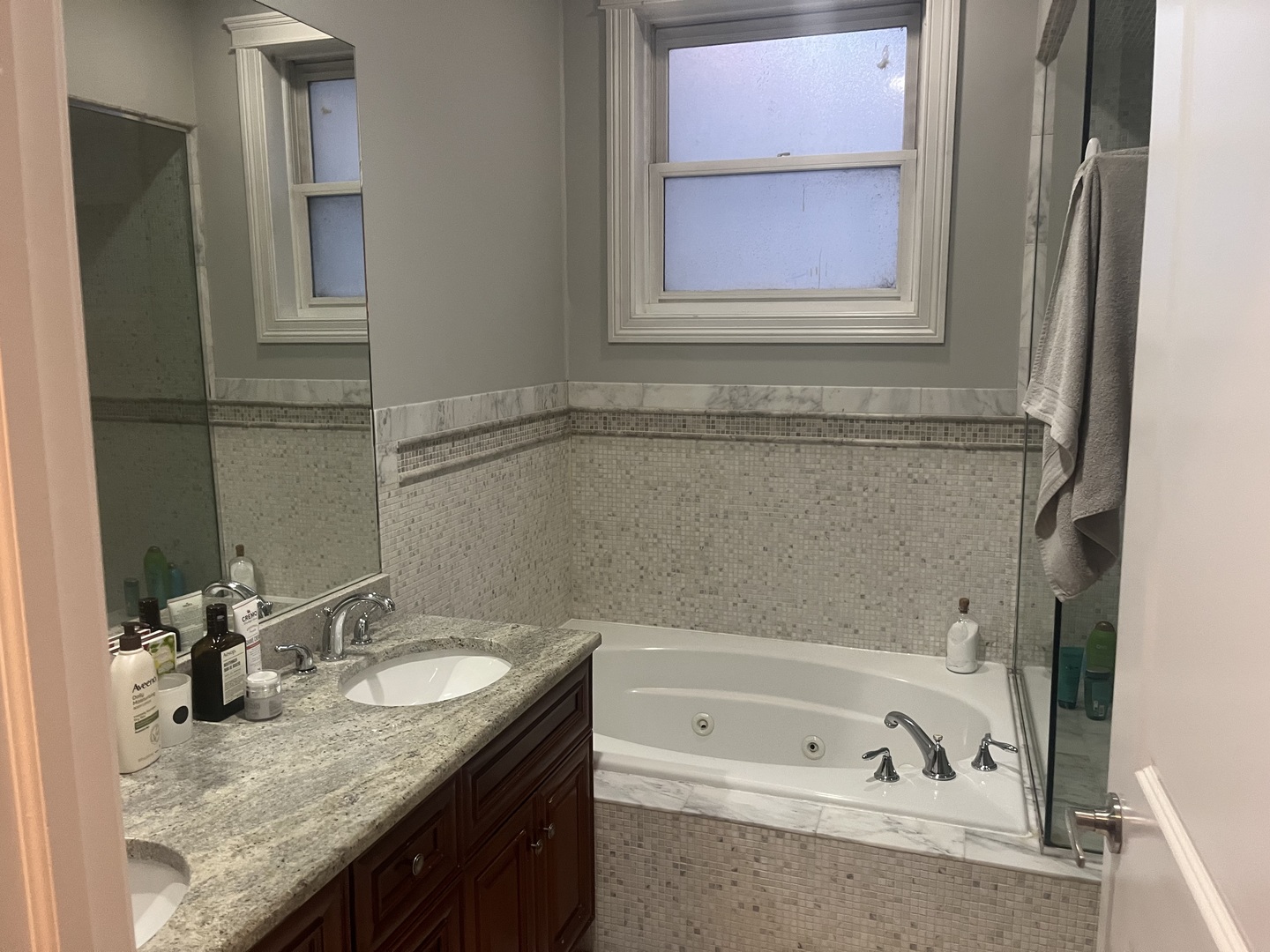 27 North Morgan Street, Unit 3 Chicago, IL 60607 - Photo 17 of 18 a bathroom with a granite countertop tub sink and mirror