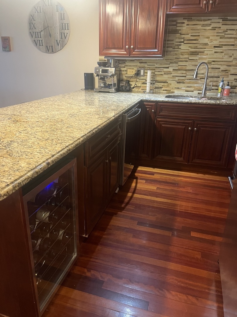 27 North Morgan Street, Unit 3 Chicago, IL 60607 - Photo 3 of 18 a kitchen with stainless steel appliances granite countertop a sink a stove and wooden floor