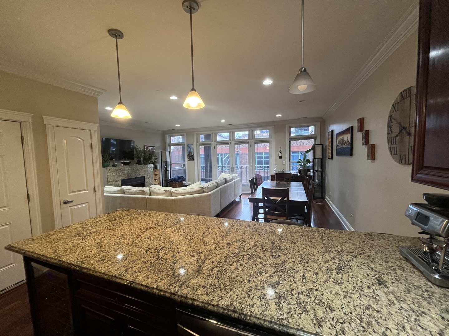27 North Morgan Street, Unit 3 Chicago, IL 60607 - Photo 4 of 18 a view of a kitchen with kitchen island stainless steel appliances sink stove dining table and chairs