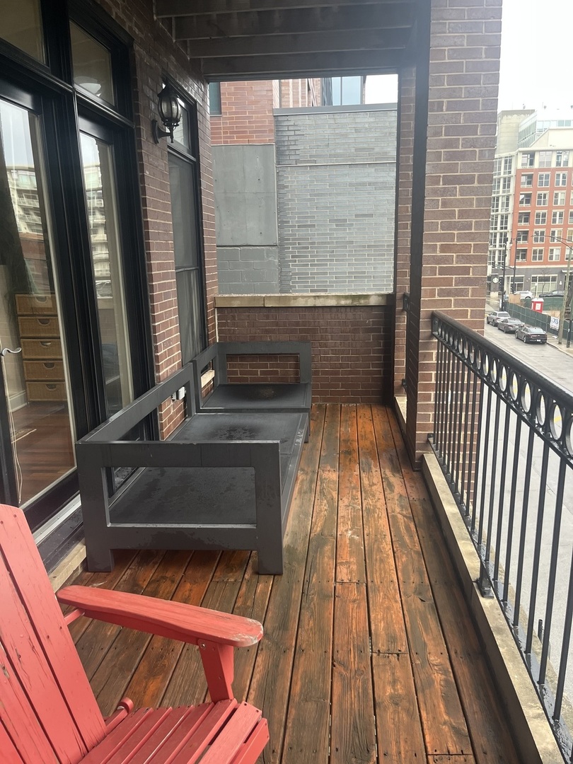 27 North Morgan Street, Unit 3 Chicago, IL 60607 - Photo 8 of 18 a view of a balcony with wooden floor