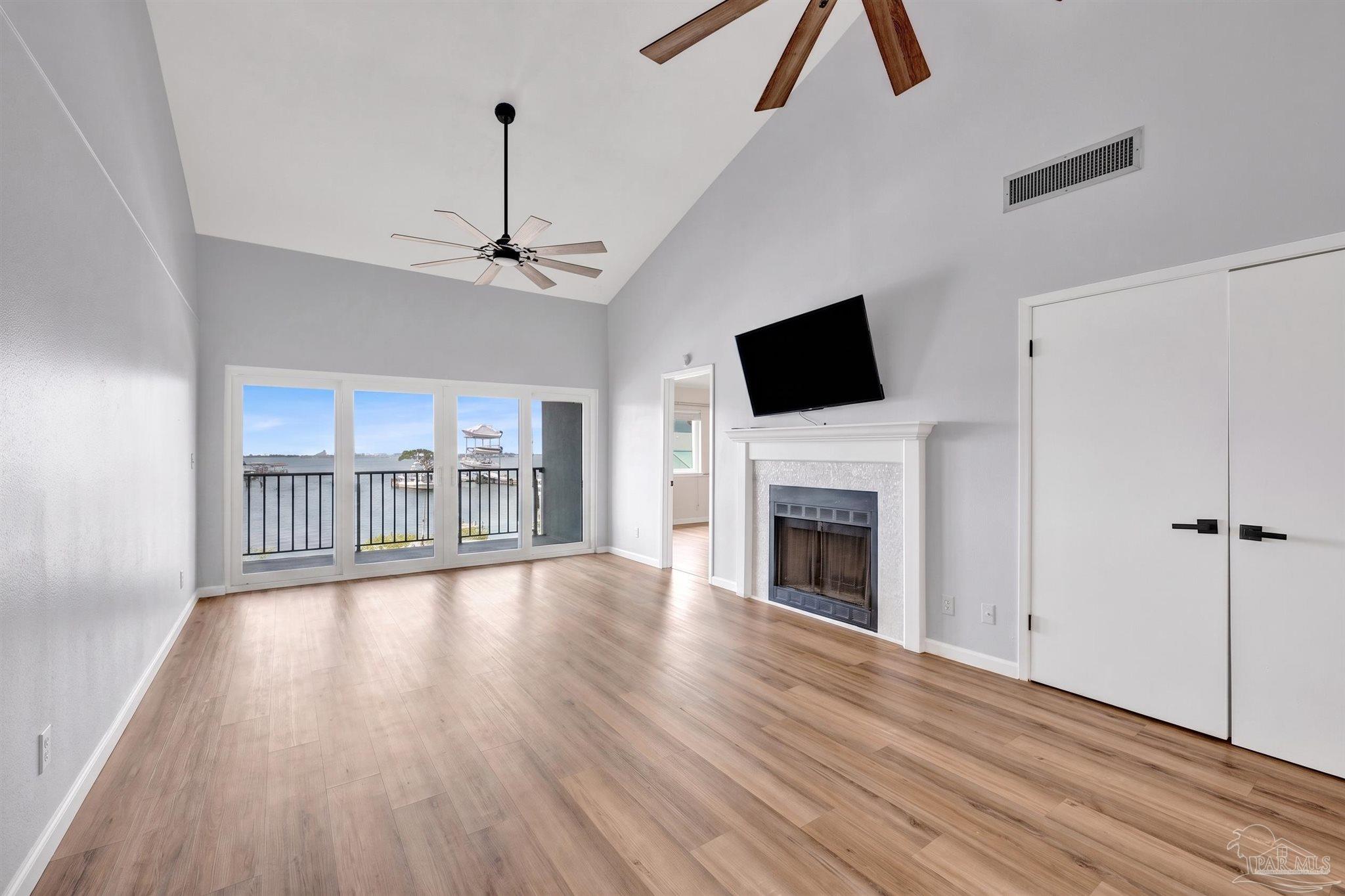 14100 River Road, Unit 334 Perdido Key, FL 32507 - Photo 11 of 35 a view of an empty room with wooden floor fireplace and a window