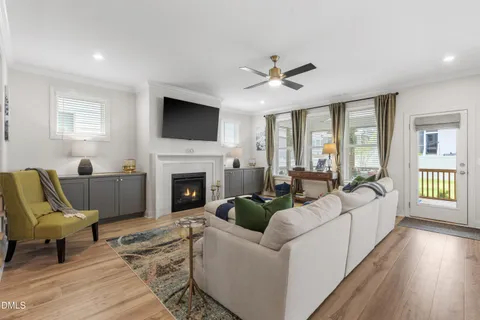 a living room with furniture a fireplace and a flat screen tv