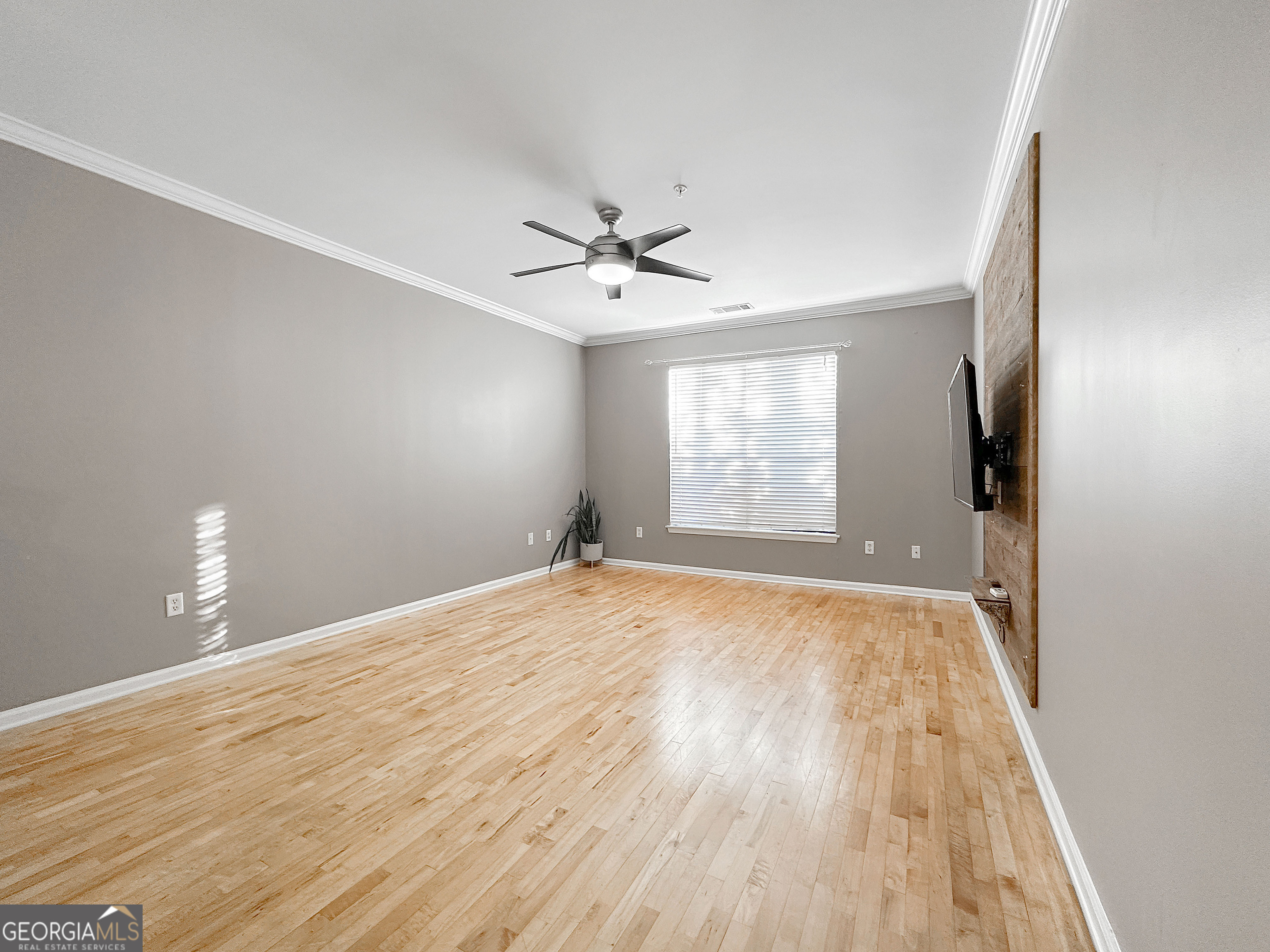 821 Ralph McGill Boulevard Northeast, Unit 3219 Atlanta, GA 30306 - Photo 2 of 12 wooden floor in an empty room with a window