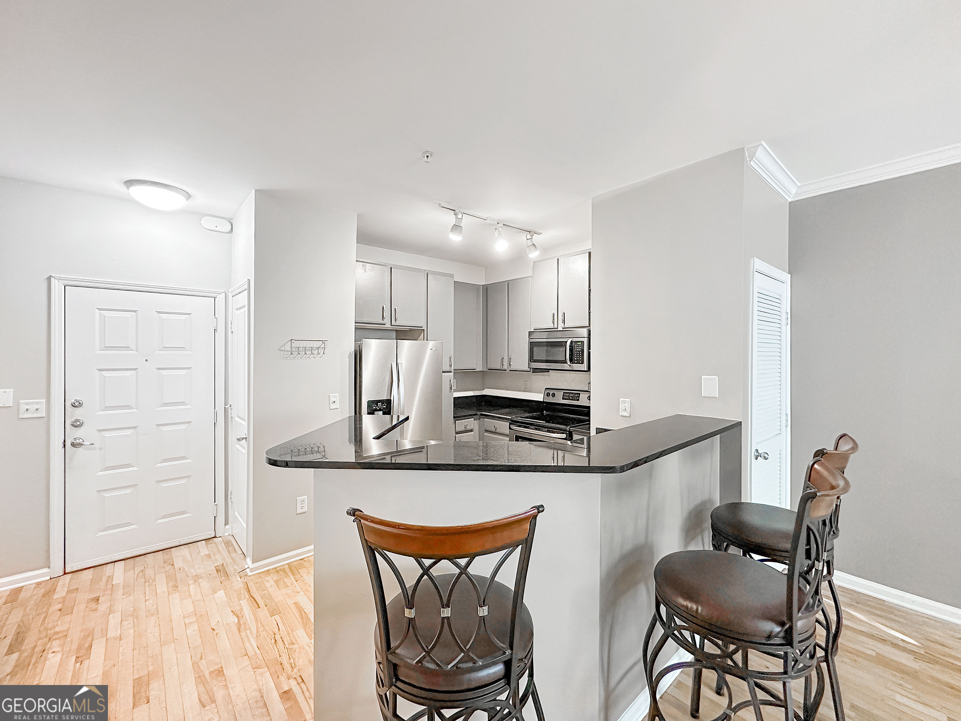 821 Ralph McGill Boulevard Northeast, Unit 3219 Atlanta, GA 30306 - Photo 5 of 12 a kitchen with stainless steel appliances granite countertop a sink and a refrigerator