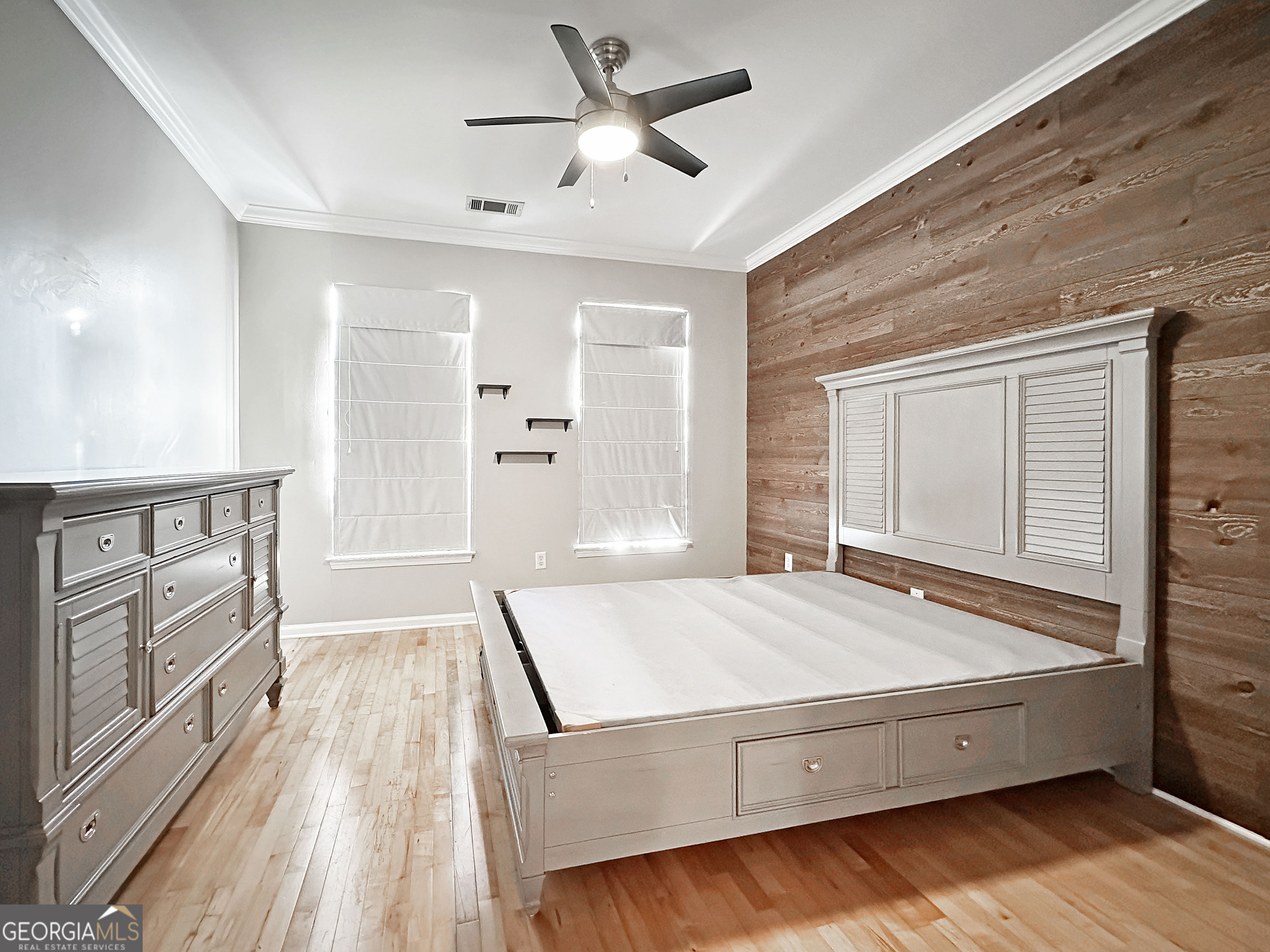 821 Ralph McGill Boulevard Northeast, Unit 3219 Atlanta, GA 30306 - Photo 8 of 12 a living room with a bed and large window with wooden floor