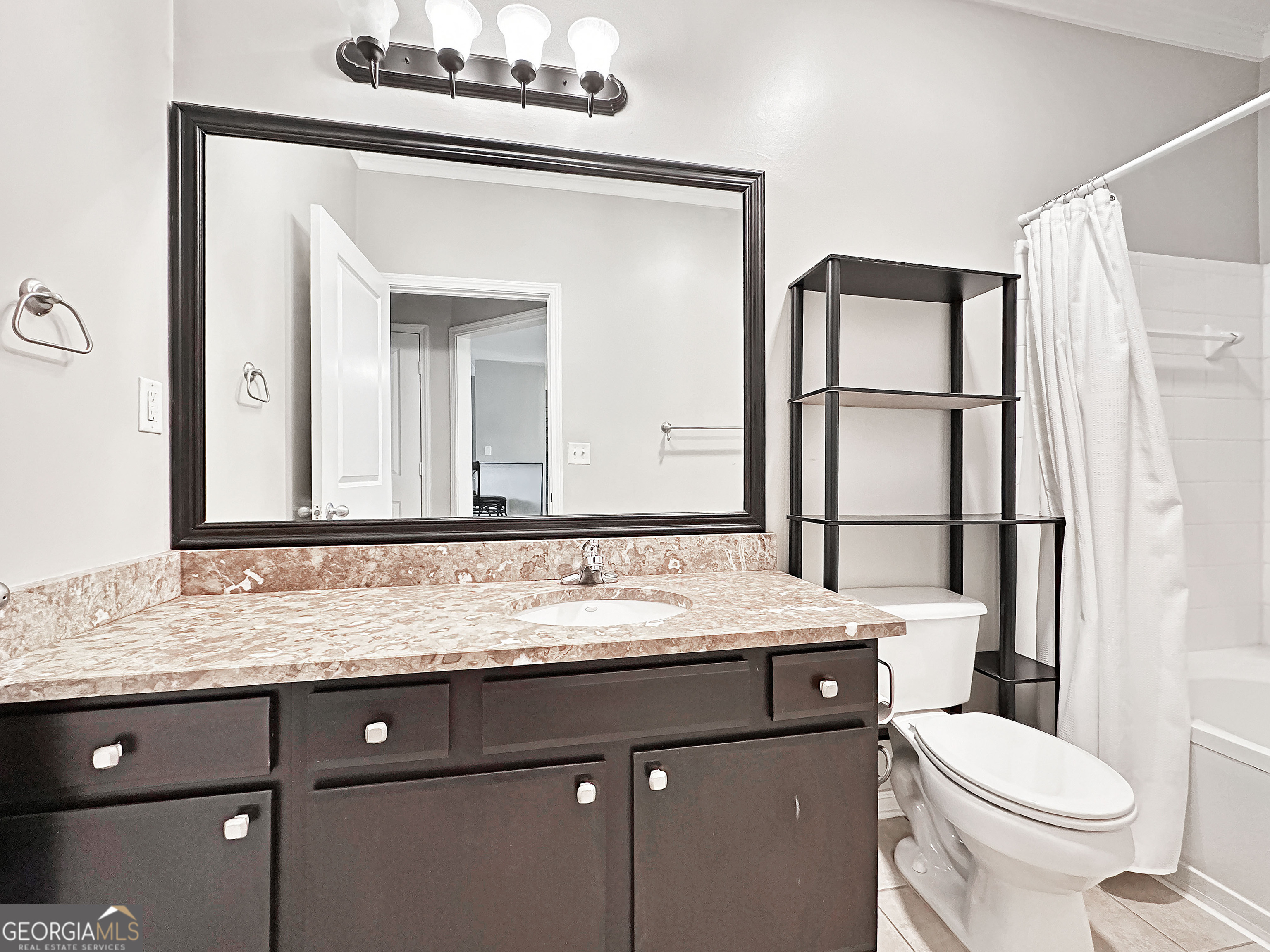 821 Ralph McGill Boulevard Northeast, Unit 3219 Atlanta, GA 30306 - Photo 10 of 12 a bathroom with a granite countertop sink mirror vanity and toilet