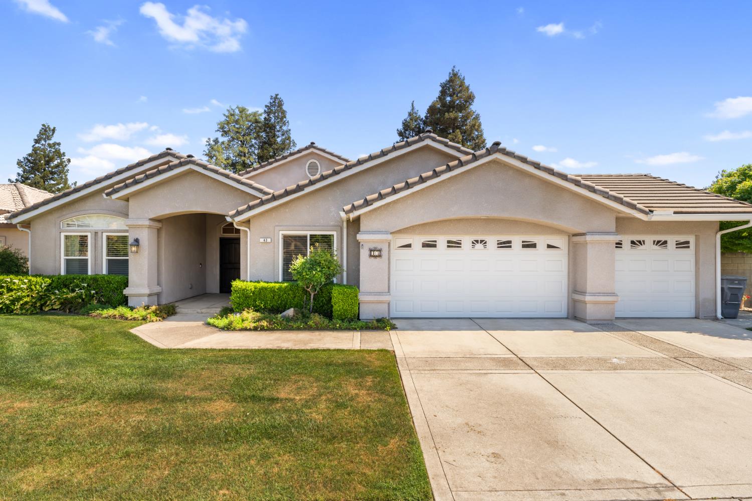 43 East Loop Madera, CA 93637 - Photo 1 of 49 a front view of a house with a yard and garage