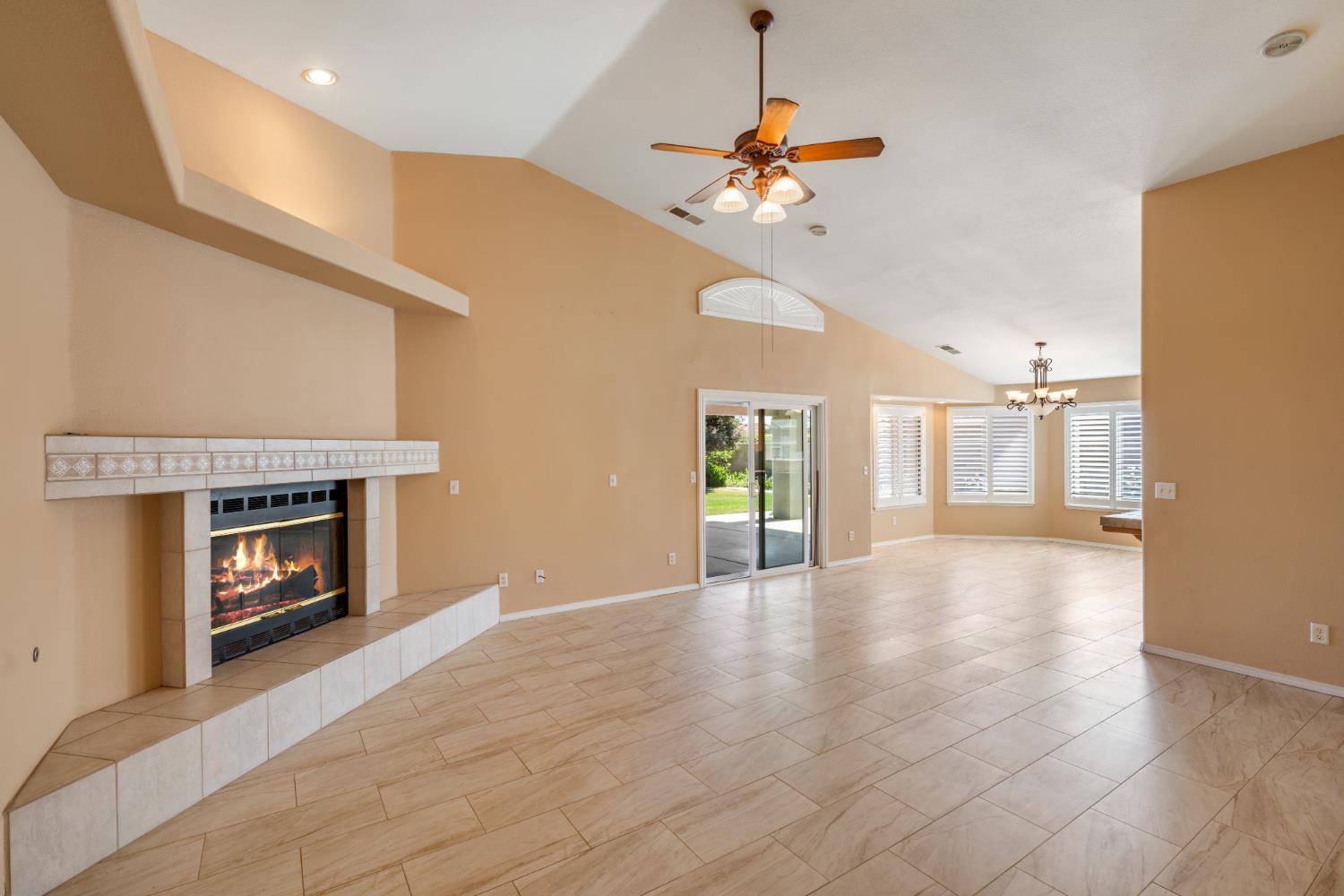 43 East Loop Madera, CA 93637 - Photo 11 of 49 a view of an empty room with a fireplace and a window