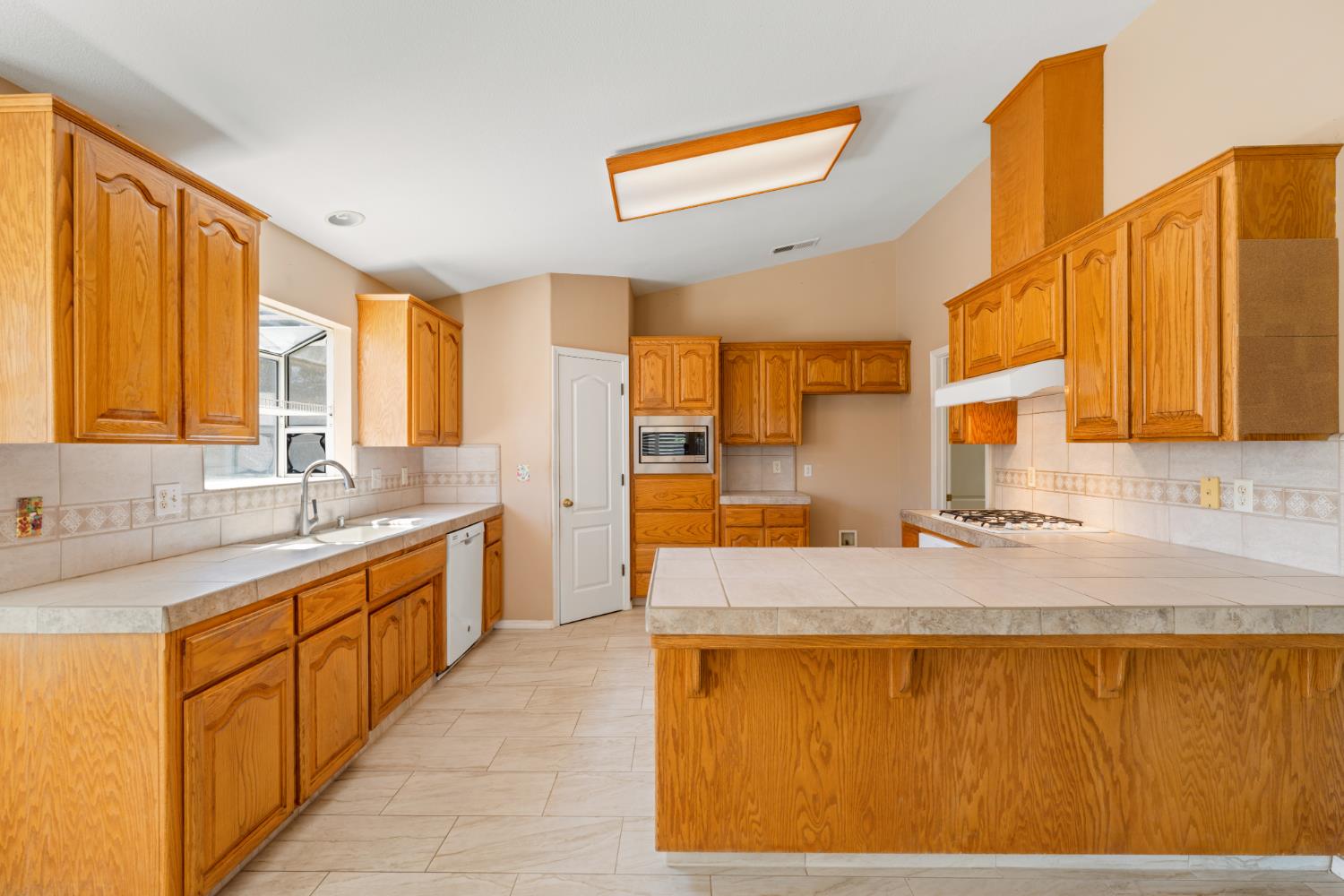 43 East Loop Madera, CA 93637 - Photo 16 of 49 a large bathroom with a granite countertop sink and a large mirror