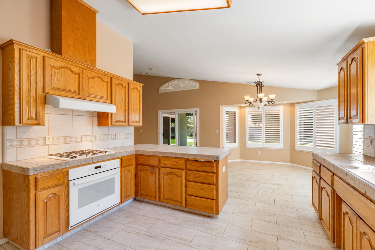 43 East Loop Madera, CA 93637 - Photo 18 of 49 a kitchen with a sink stove and cabinets