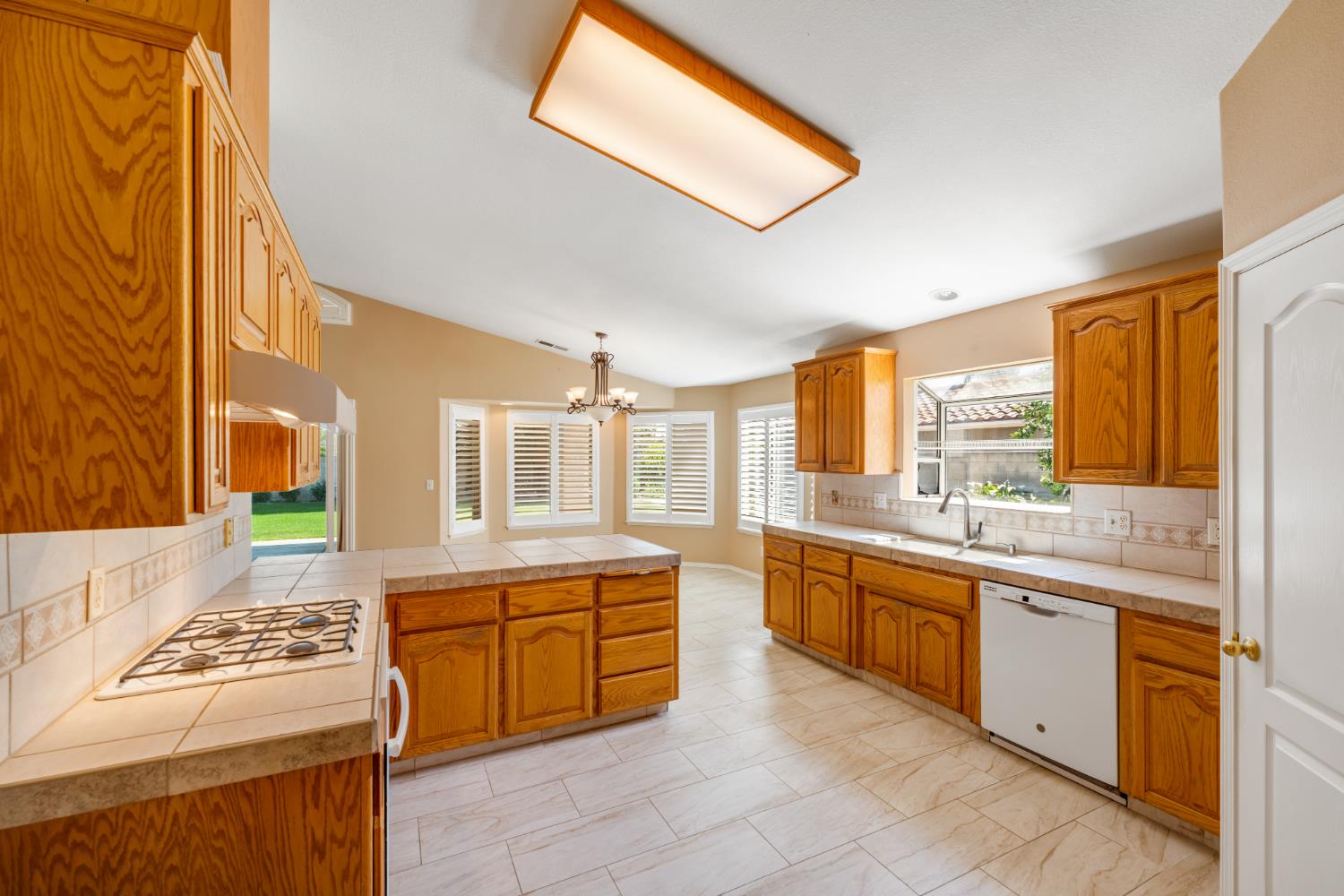 43 East Loop Madera, CA 93637 - Photo 19 of 49 a large kitchen with stainless steel appliances granite countertop a stove and a sink