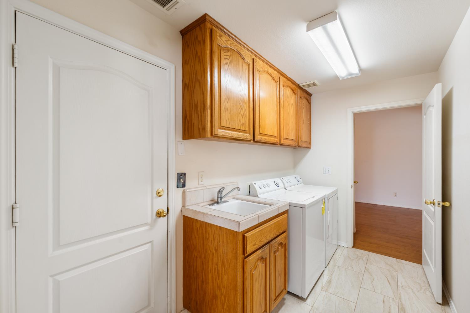 43 East Loop Madera, CA 93637 - Photo 20 of 49 a utility room with cabinets washer and dryer