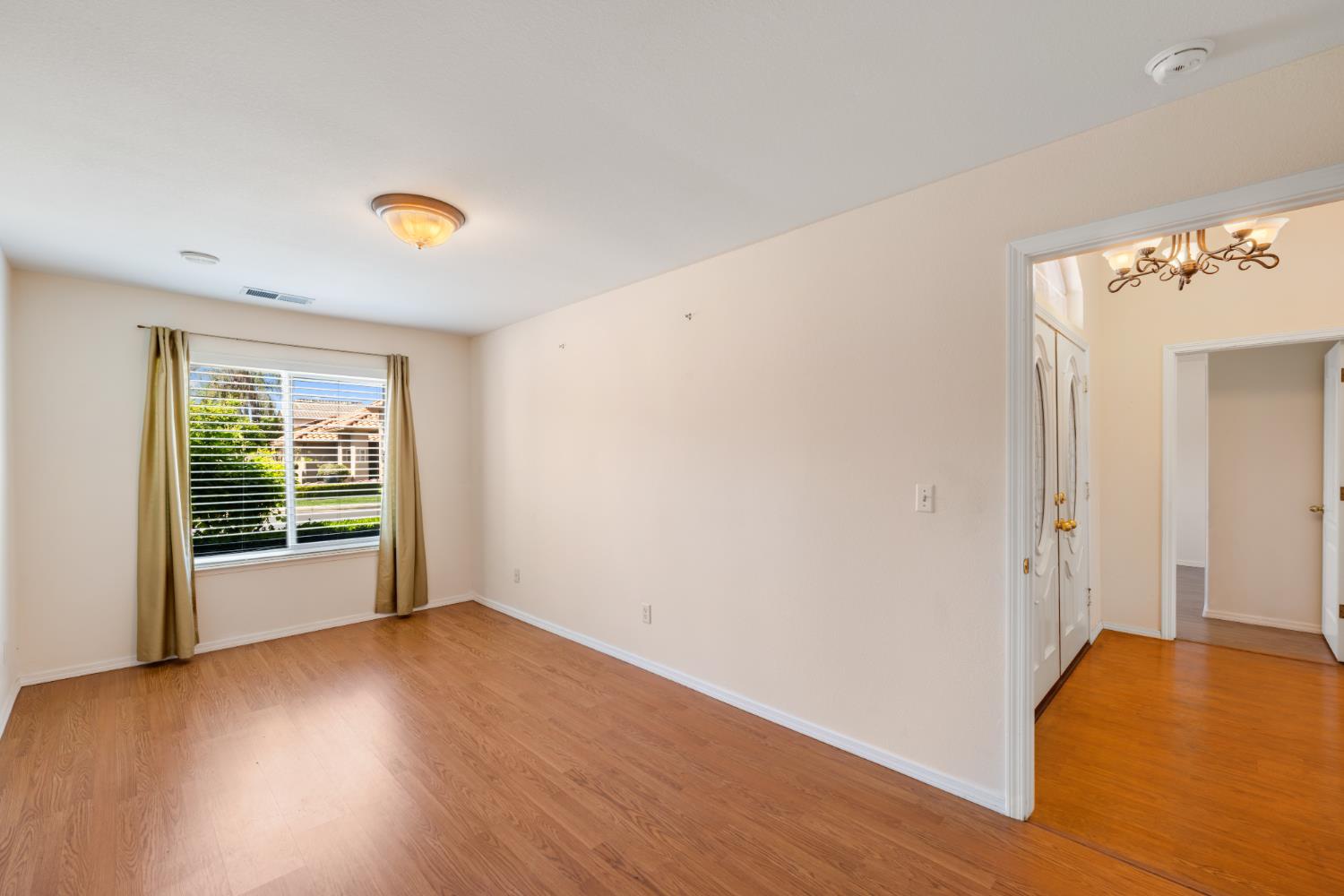 43 East Loop Madera, CA 93637 - Photo 22 of 49 an empty room with wooden floor and windows
