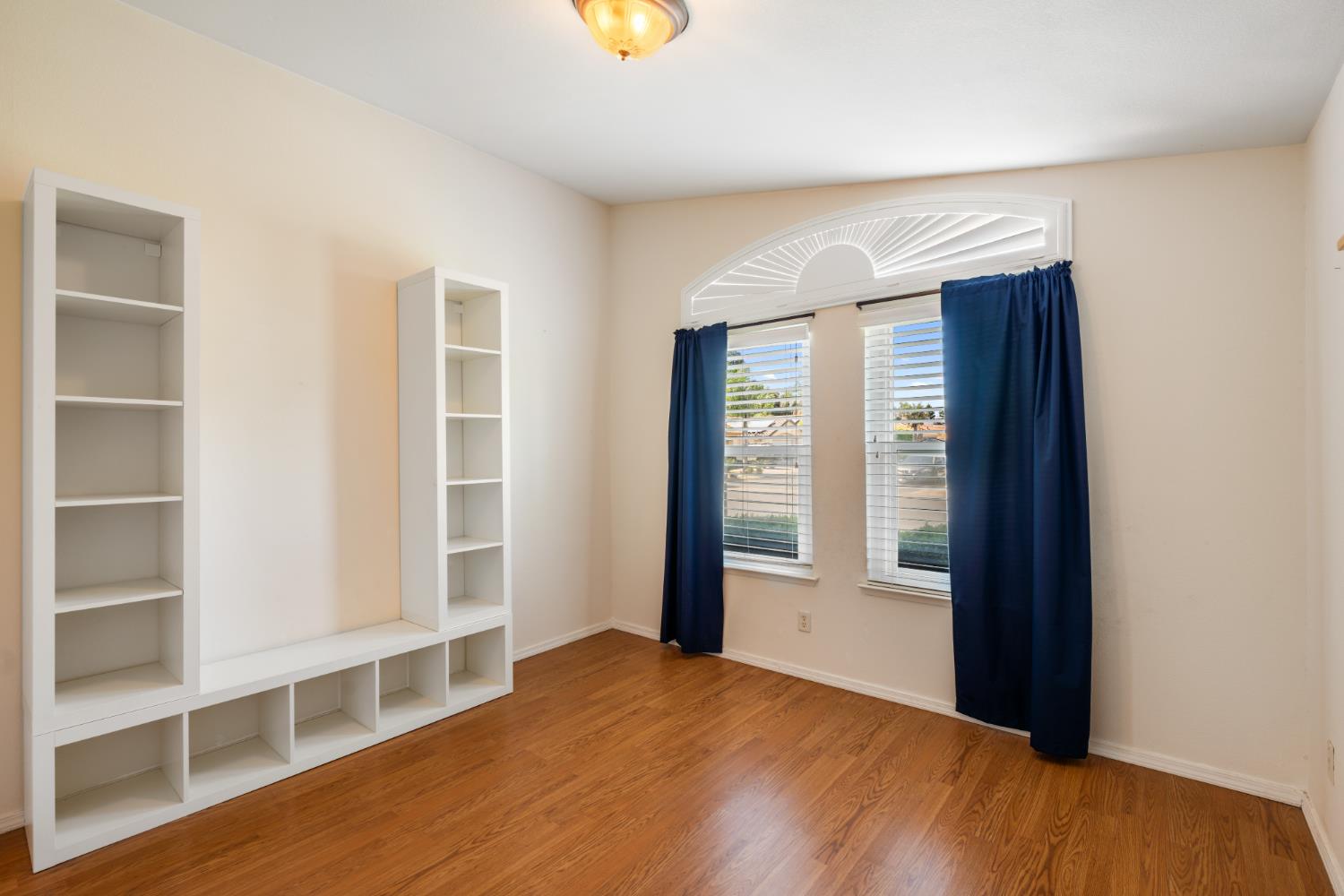 43 East Loop Madera, CA 93637 - Photo 24 of 49 a view of an empty room with a window and wooden floor