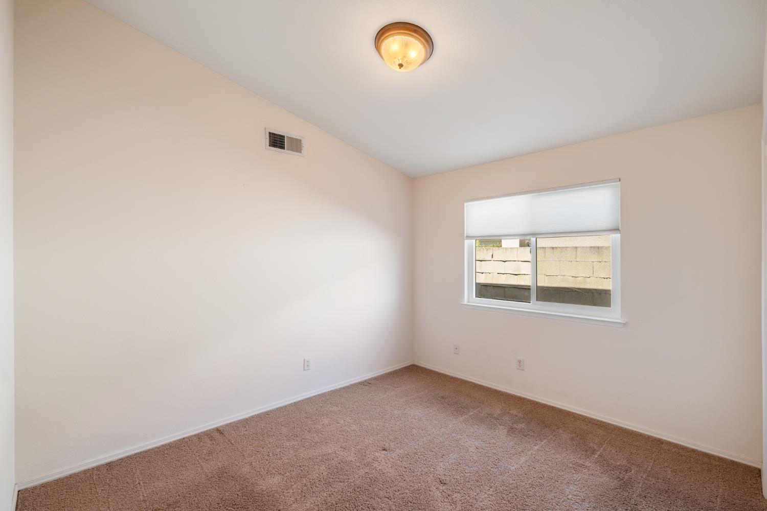 43 East Loop Madera, CA 93637 - Photo 27 of 49 an empty room with a window