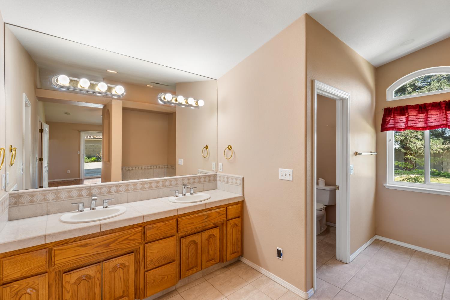 43 East Loop Madera, CA 93637 - Photo 33 of 49 a spacious bathroom with a double vanity sink a large mirror and a shower