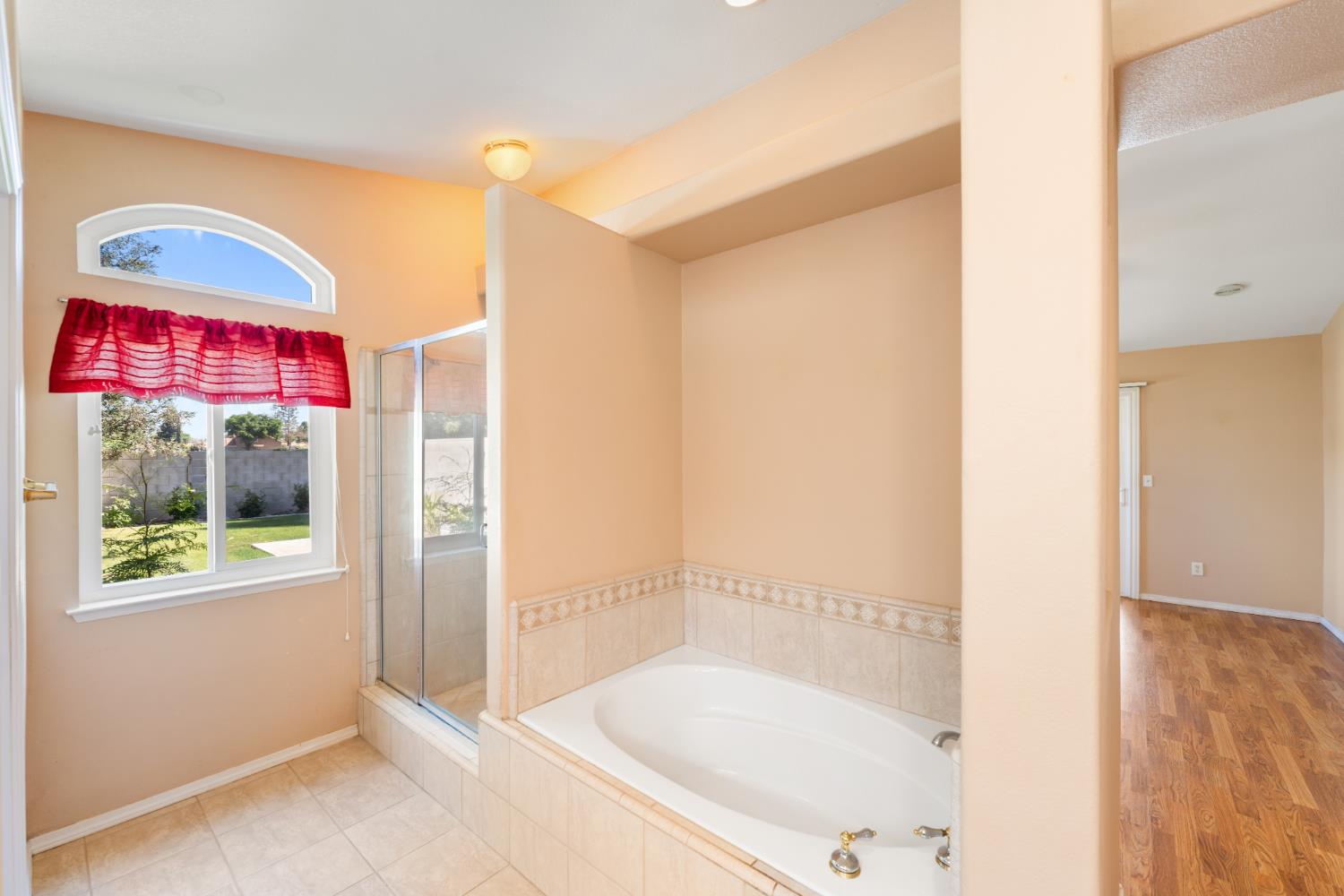 43 East Loop Madera, CA 93637 - Photo 34 of 49 a bathroom with a bathtub and a shower