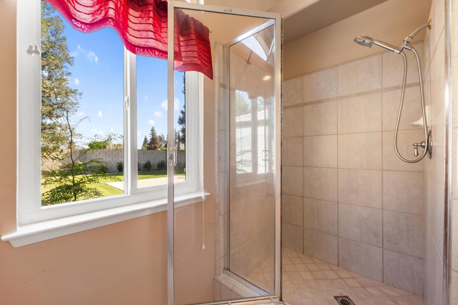 43 East Loop Madera, CA 93637 - Photo 36 of 49 a bathroom with a shower and a window