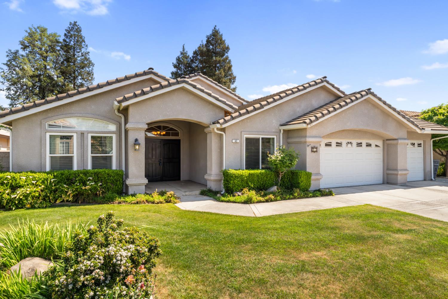 43 East Loop Madera, CA 93637 - Photo 4 of 49 a front view of a house with a yard and garage