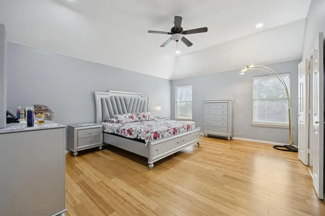 a bedroom with a large bed and a chandelier