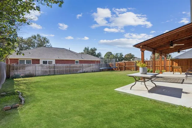 a view of yard with patio