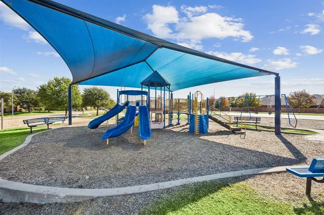 a view of a grassy field with an trees