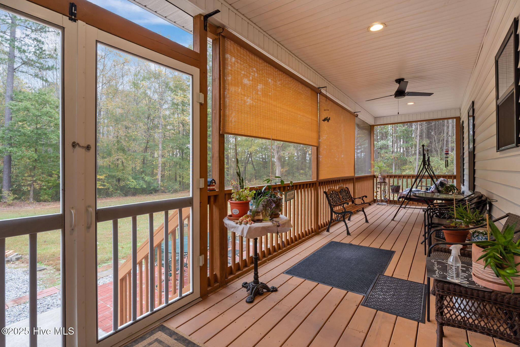 457 Reynolds Road Louisburg, NC 27549 - Photo 24 of 38 Relaxing screened-in back porch with two ceiling fans.