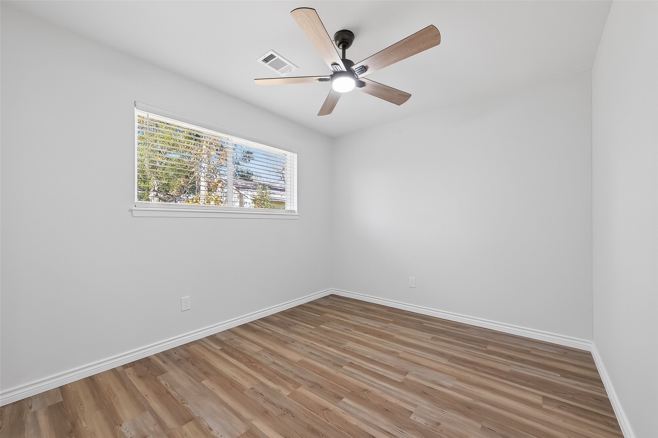 1920 Ripple Creek Drive Rosenberg, TX 77471 - Photo 16 of 26 wooden floor in an empty room with a window
