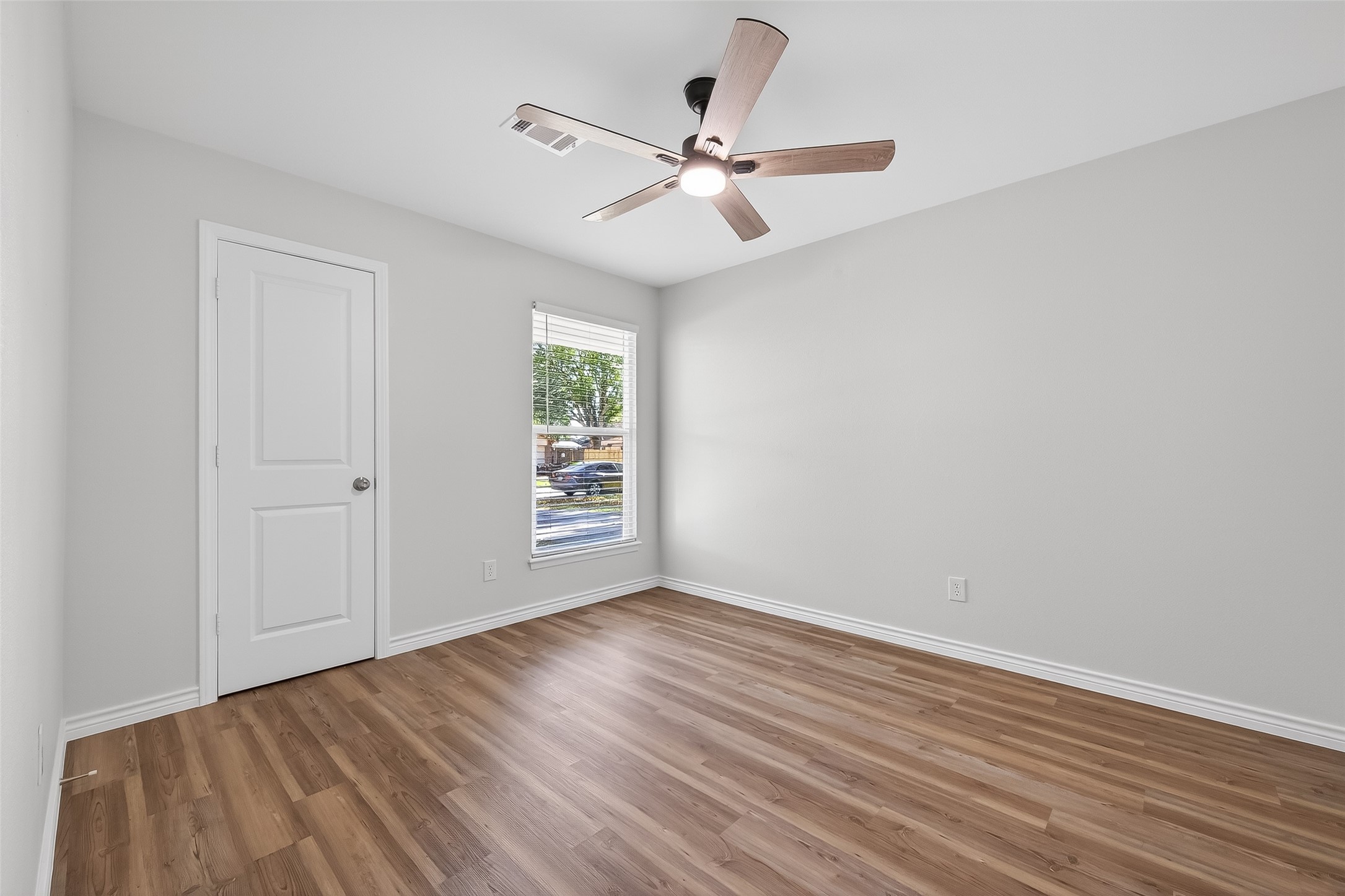 1920 Ripple Creek Drive Rosenberg, TX 77471 - Photo 18 of 26 wooden floor in an empty room with a window