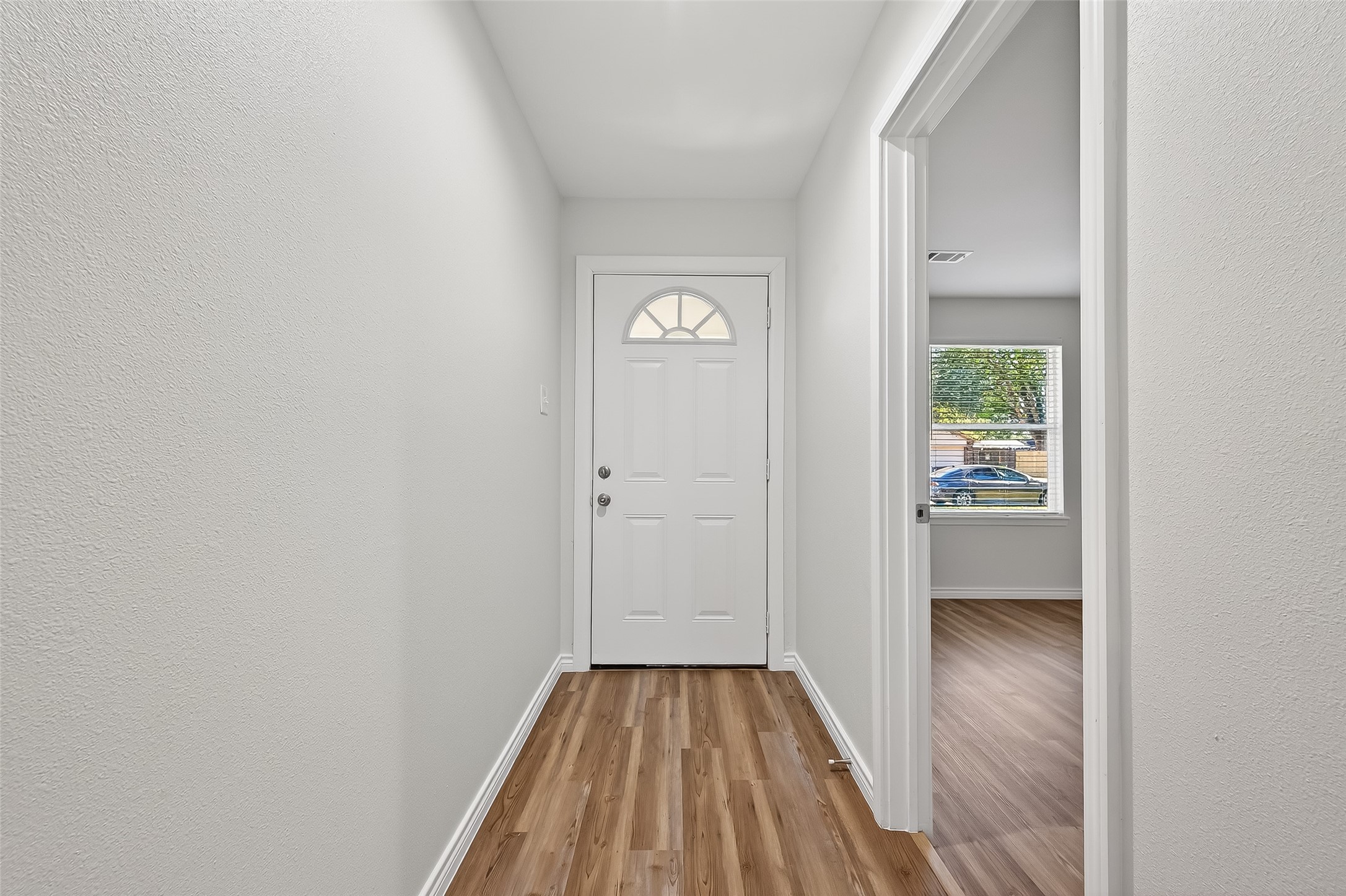 1920 Ripple Creek Drive Rosenberg, TX 77471 - Photo 3 of 26 a view of a hallway with wooden floor and a bathroom