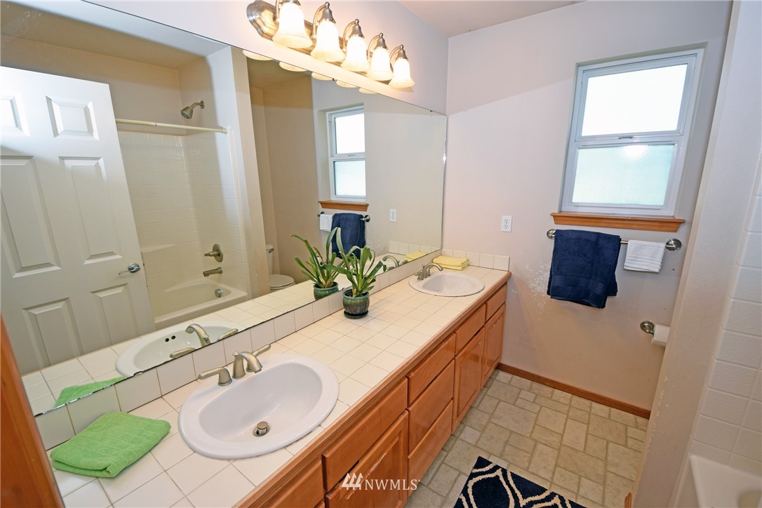 16026 39th Avenue Southeast Bothell, WA 98012 - Photo 22 of 31 a bathroom with a sink double vanity and a mirror