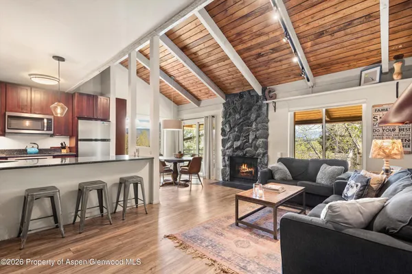 a living room with fireplace furniture and a wooden floor