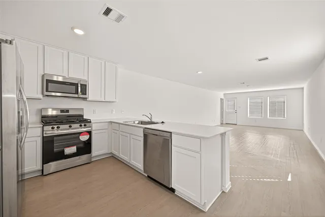 a kitchen with a sink and cabinets