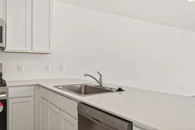 a stove top oven sitting inside of a kitchen