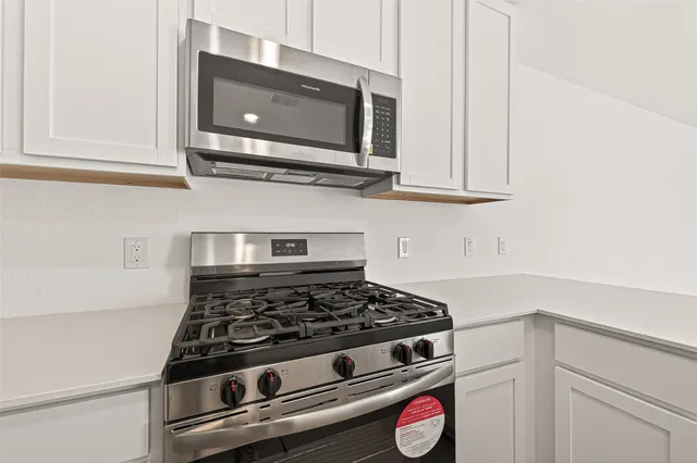 a kitchen with sink and mirror