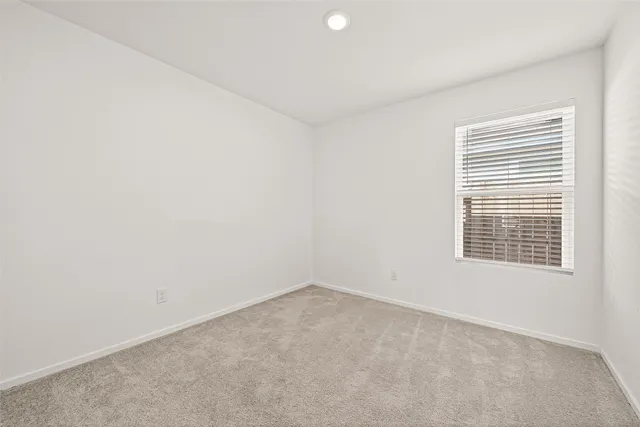 an empty room with a empty space and window