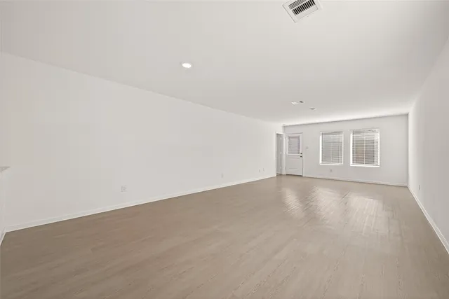 an empty room with a empty space and windows