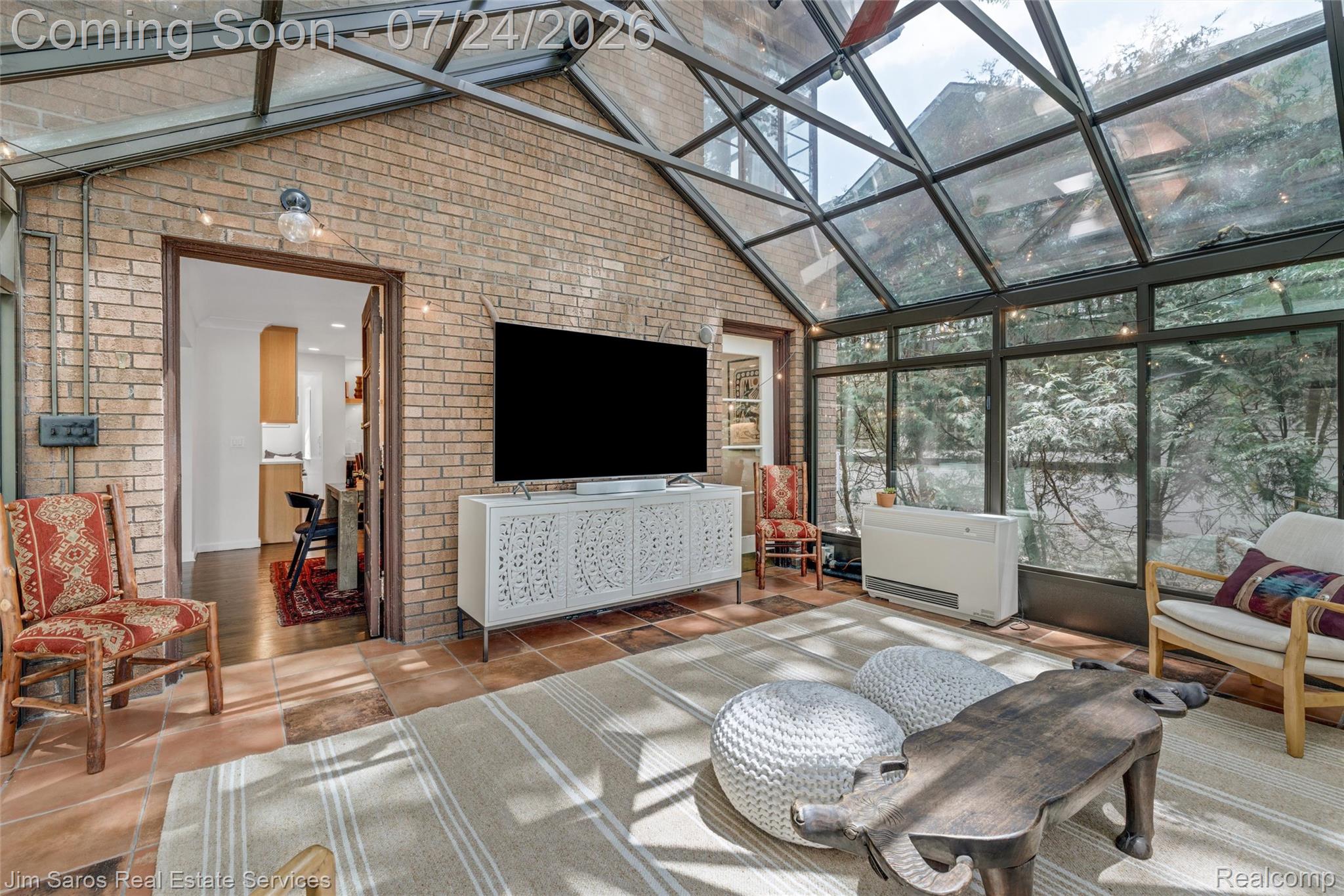 757 Middlesex Road Grosse Pointe, MI 48230 - Photo 13 of 45 Sunroom featuring extensive glass paneling, brick accent walls, and terracotta-style floor tiles