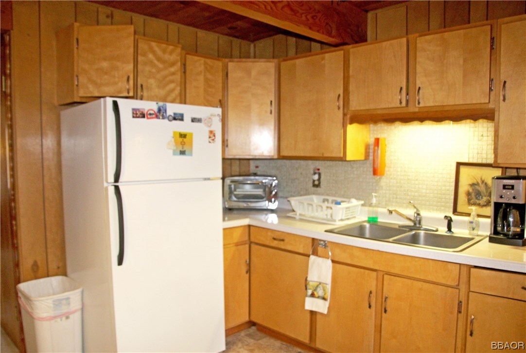 229 Pine Lane Sugarloaf, CA 92386 - Photo 9 of 24 a white refrigerator freezer sitting inside of a kitchen