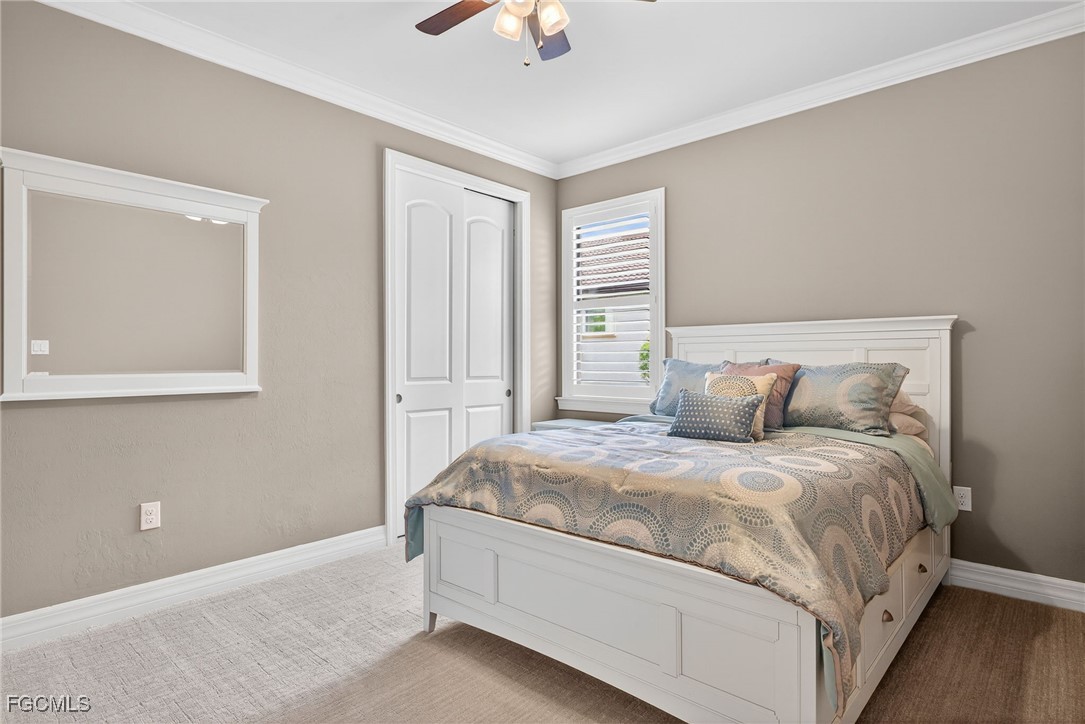 11800 Benchley Court Fort Myers, FL 33913 - Photo 21 of 50 a bedroom with a bed and a chandelier