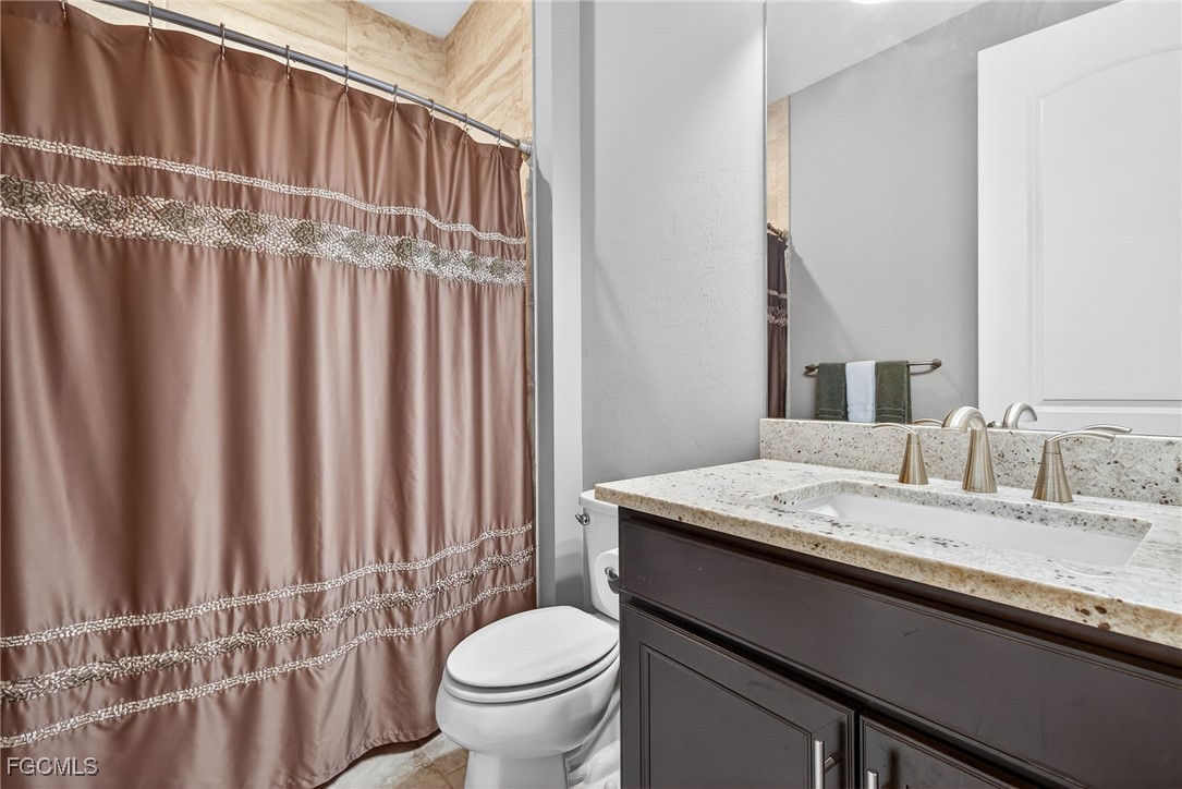 11800 Benchley Court Fort Myers, FL 33913 - Photo 23 of 50 a bathroom with a granite countertop sink and a toilet