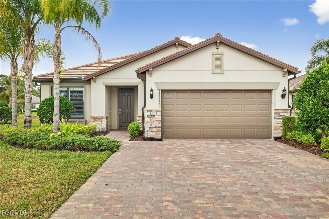 11800 Benchley Court Fort Myers, FL 33913 - Photo 30 of 50 a front view of a house with a garden