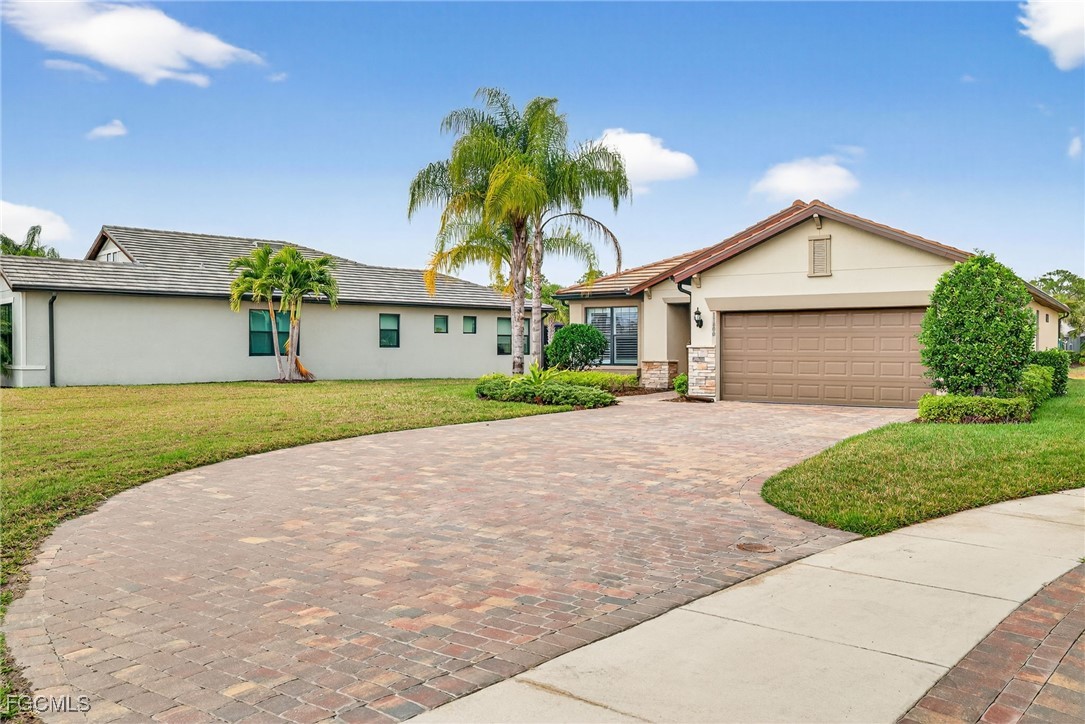 11800 Benchley Court Fort Myers, FL 33913 - Photo 3 of 50 a front view of a house with a garden and plants