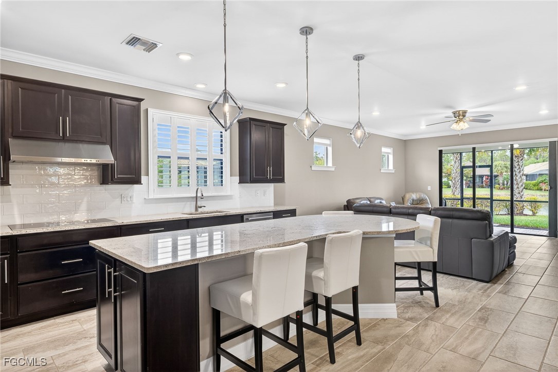 11800 Benchley Court Fort Myers, FL 33913 - Photo 4 of 50 a kitchen with a table chairs sink and cabinets
