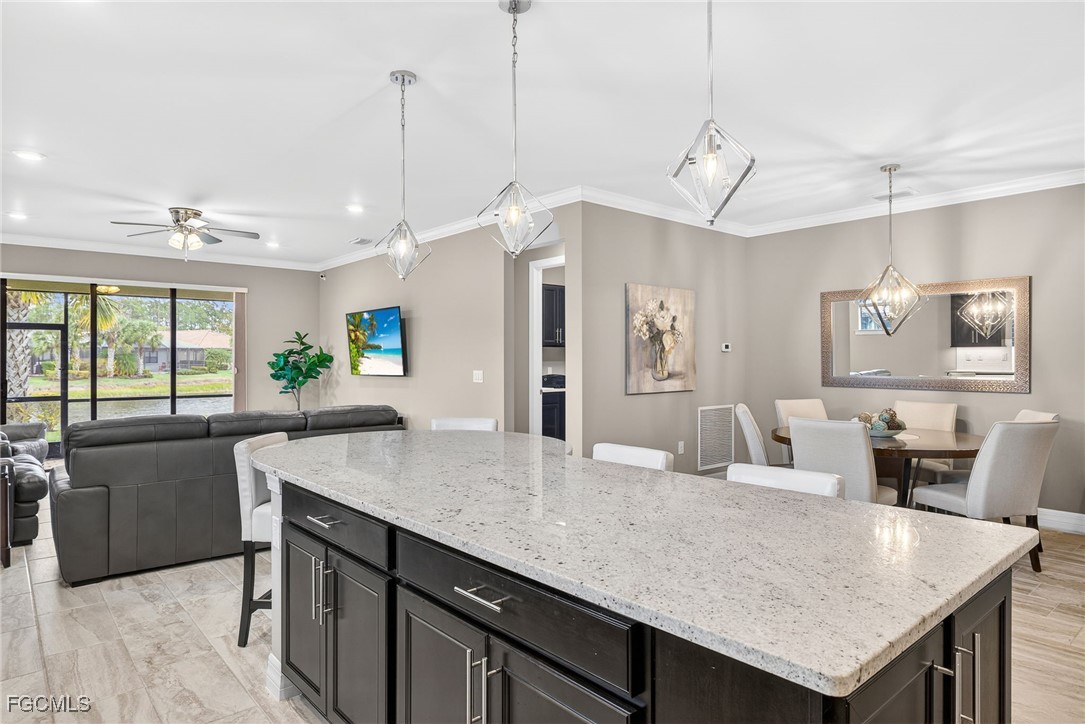 11800 Benchley Court Fort Myers, FL 33913 - Photo 5 of 50 a kitchen with granite countertop cabinets table and chairs