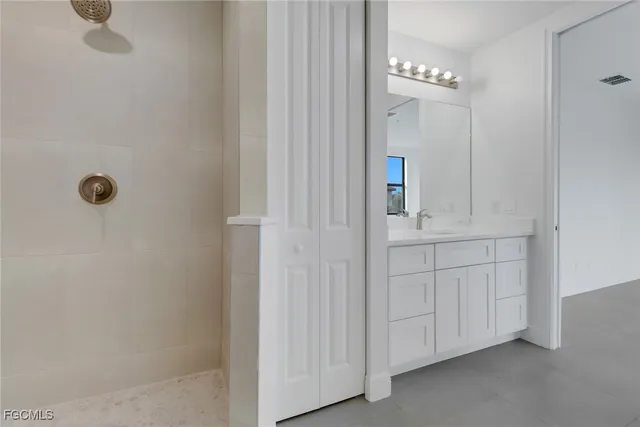 a bathroom with a double vanity sink a mirror and shower