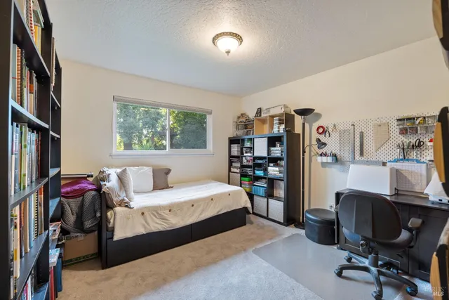 a bedroom with furniture and a workspace