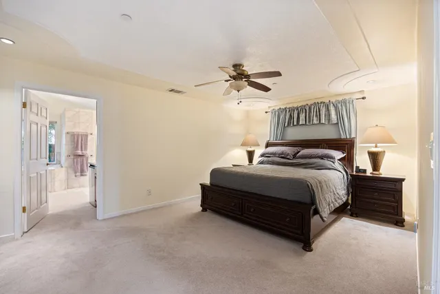 a spacious bedroom with a bed and a chandelier