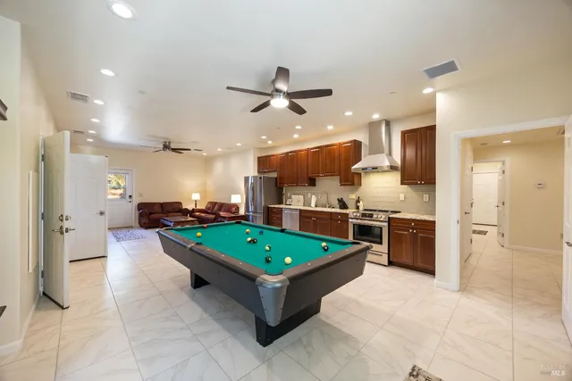 a large kitchen with a table and chairs