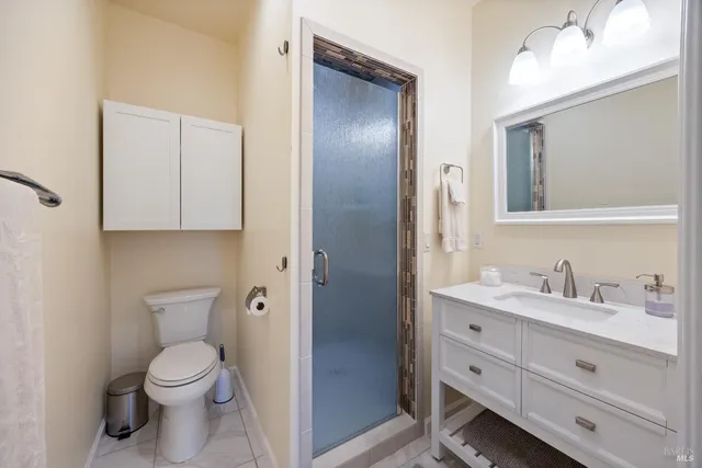 a bathroom with a toilet a sink and mirror